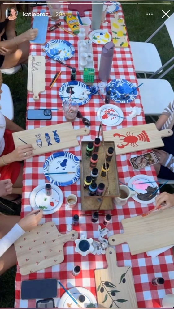 A picnic-style craft table with gingham and paint